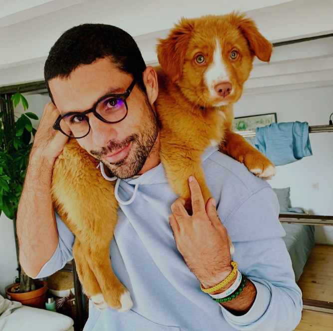 Pablo with his puppy riding on his shoulders